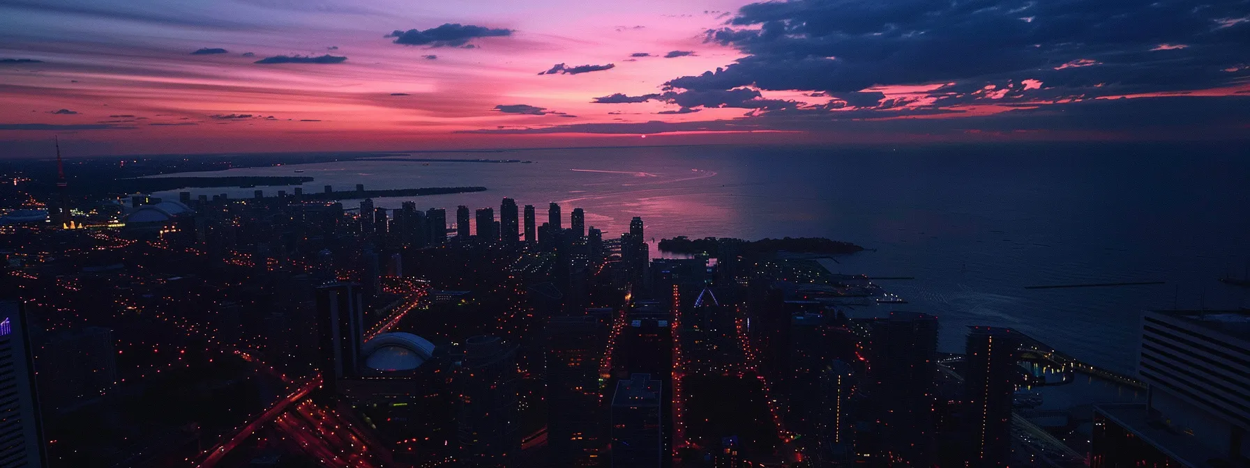 capturing toronto's impressive skyline at dusk from the cn tower observation deck.